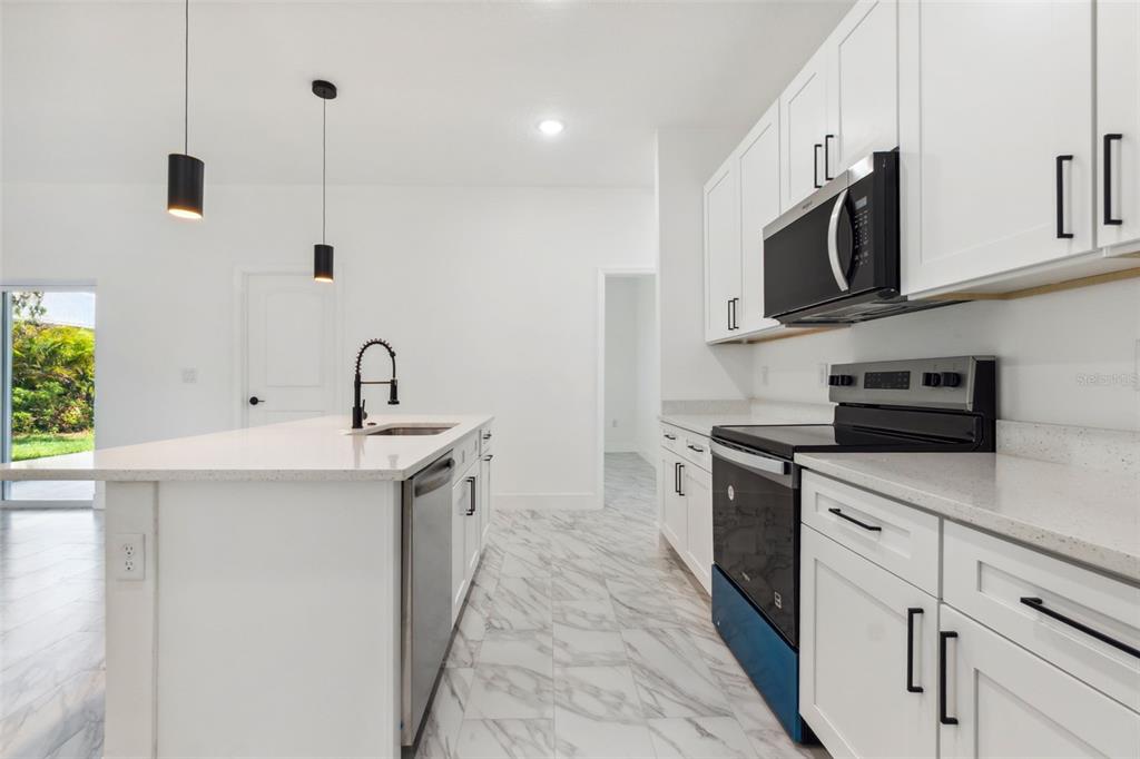8 Cleat Court Placida, FL 33946 - Photo 11 of 24 a kitchen with stainless steel appliances a sink a stove and a microwave