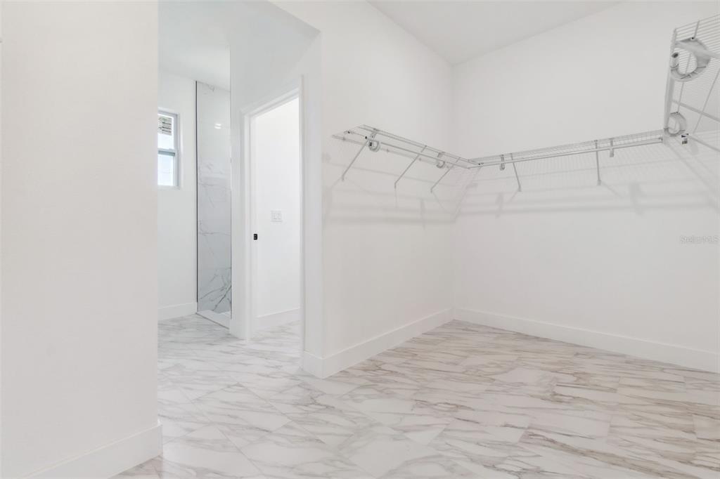8 Cleat Court Placida, FL 33946 - Photo 14 of 24 a view of an empty walk in closet with empty racks