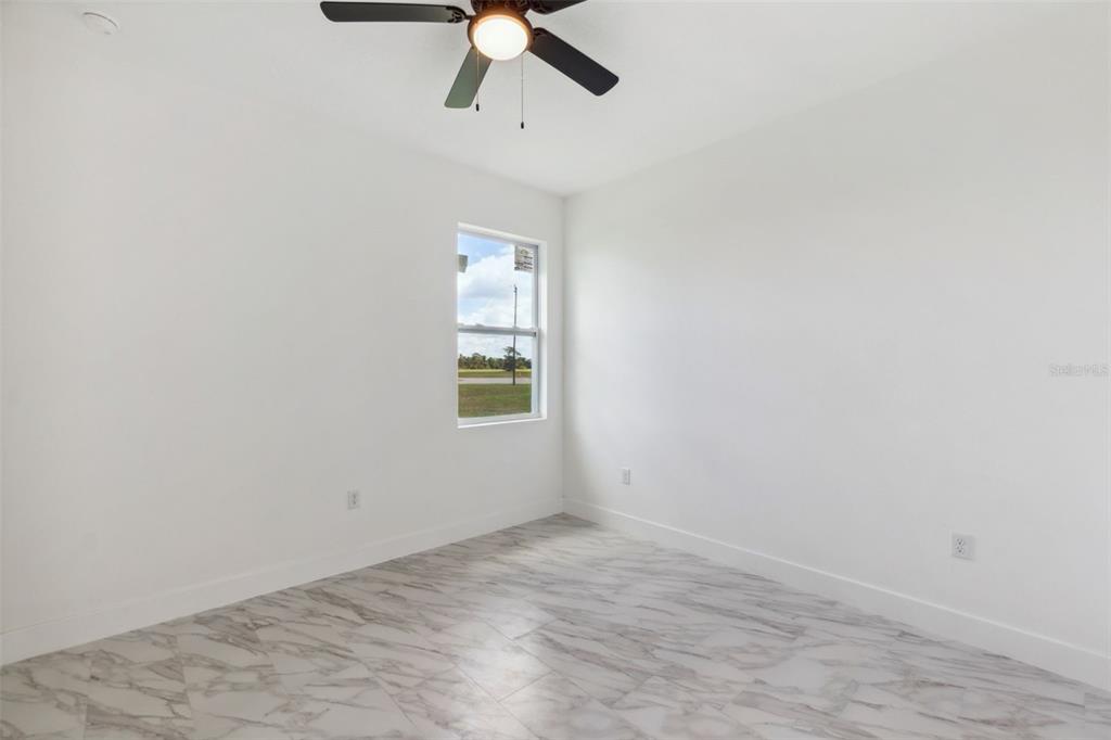 8 Cleat Court Placida, FL 33946 - Photo 19 of 24 an empty room with a window and a ceiling fan