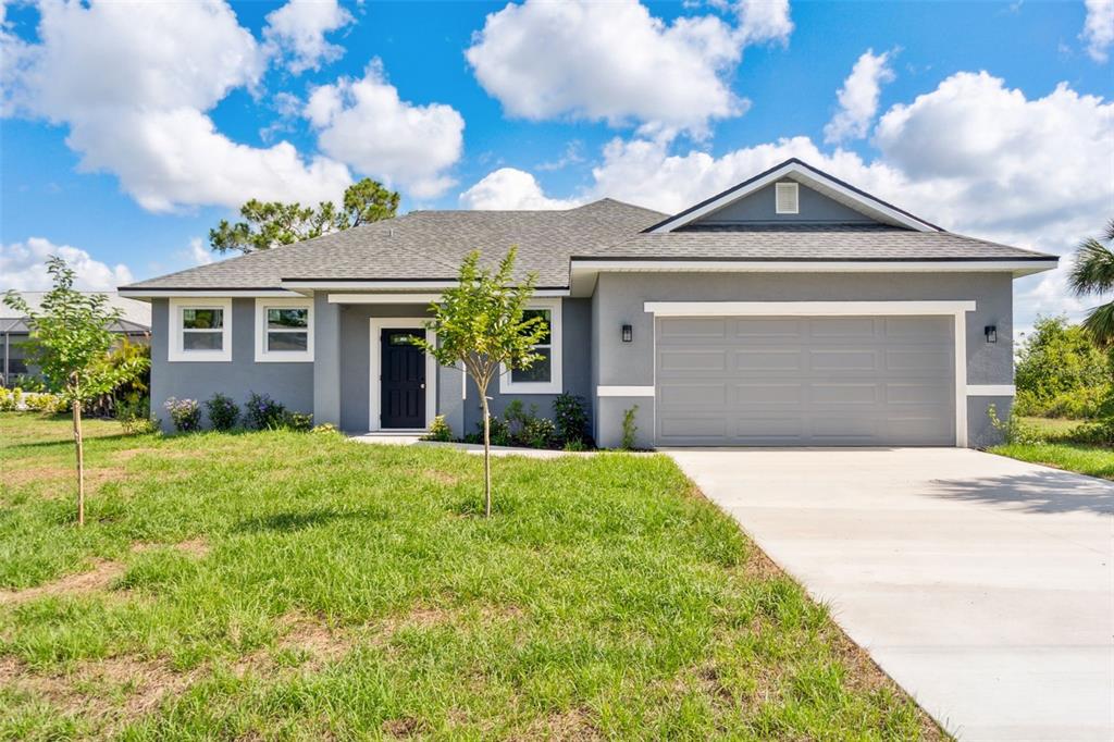 8 Cleat Court Placida, FL 33946 - Photo 2 of 24 a front view of a house with a yard and garage