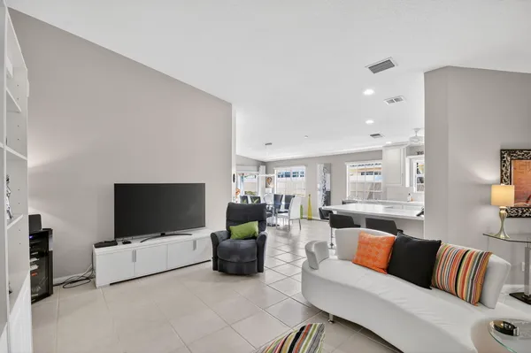 a view of a patio with table and chairs with wooden floor and fence