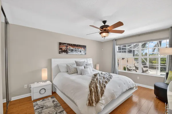 a dining room with furniture a floor to ceiling window and a flat screen tv
