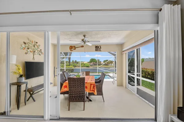 a front view of a house with a yard and potted plants