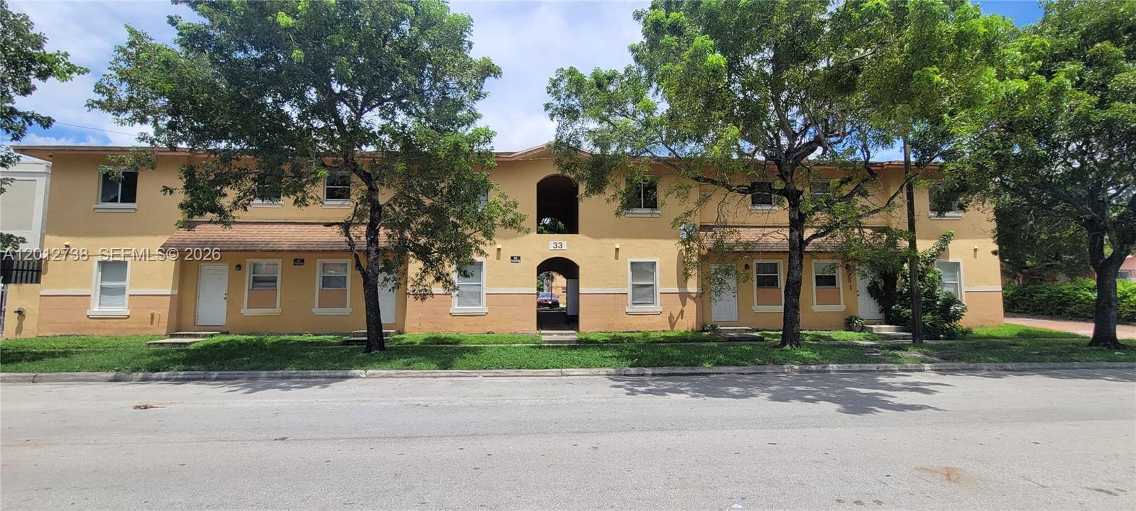 33 East 20th Street, Unit 206 Hialeah, FL 33010 - Photo 1 of 15 a front view of a house with garden