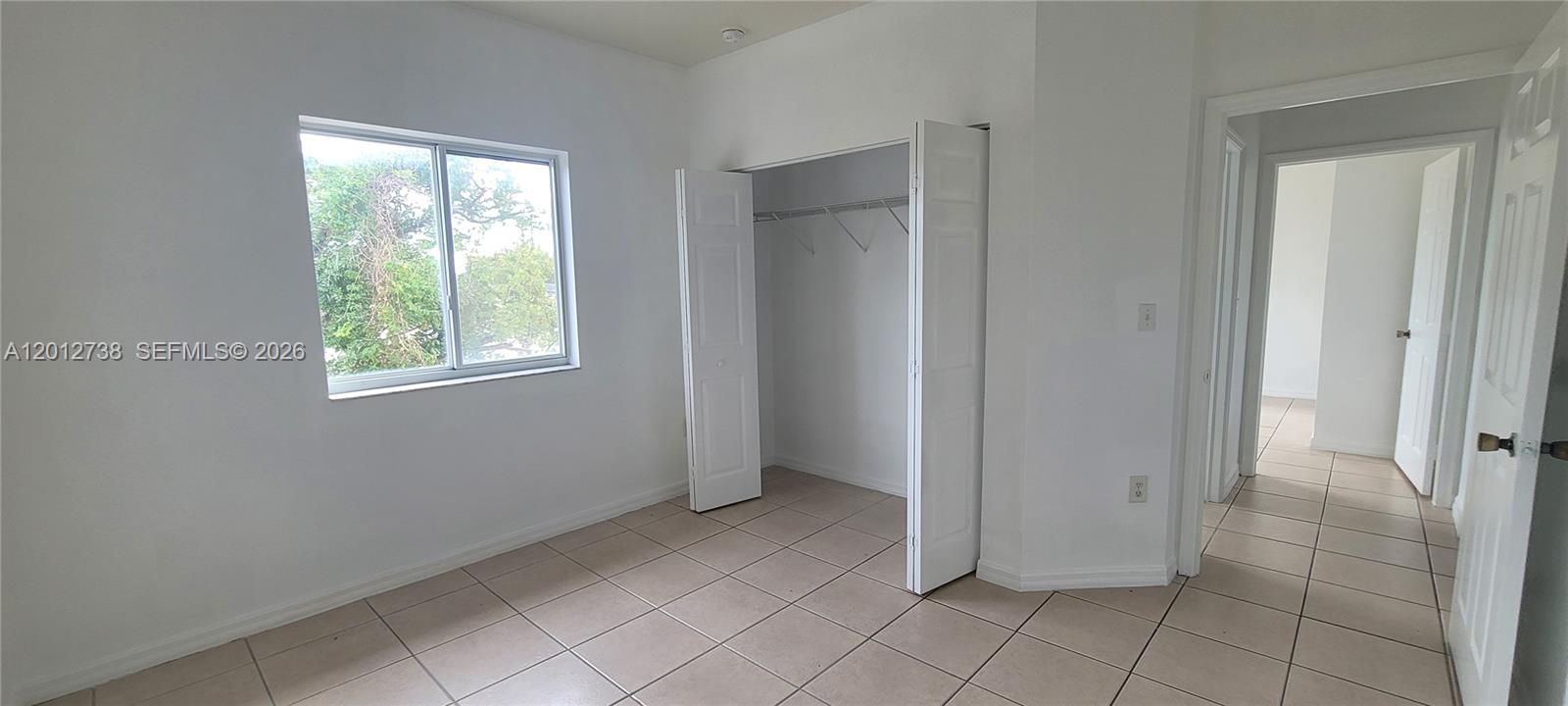 33 East 20th Street, Unit 206 Hialeah, FL 33010 - Photo 12 of 15 an empty room with windows