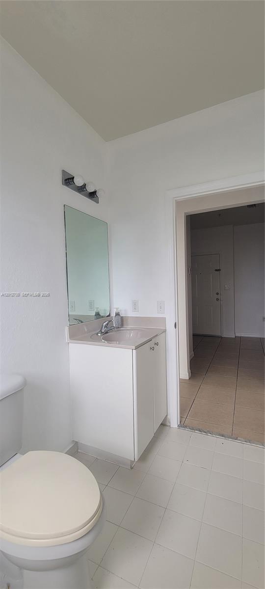 33 East 20th Street, Unit 206 Hialeah, FL 33010 - Photo 14 of 15 a bathroom with a toilet sink and mirror