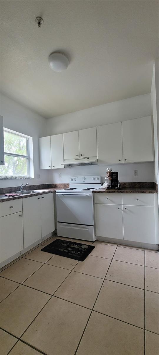 33 East 20th Street, Unit 206 Hialeah, FL 33010 - Photo 6 of 15 a kitchen with a sink window and cabinets