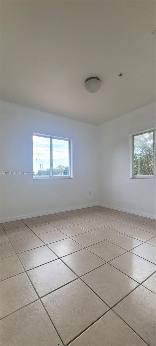 33 East 20th Street, Unit 206 Hialeah, FL 33010 - Photo 10 of 15 a view of an empty room with a window
