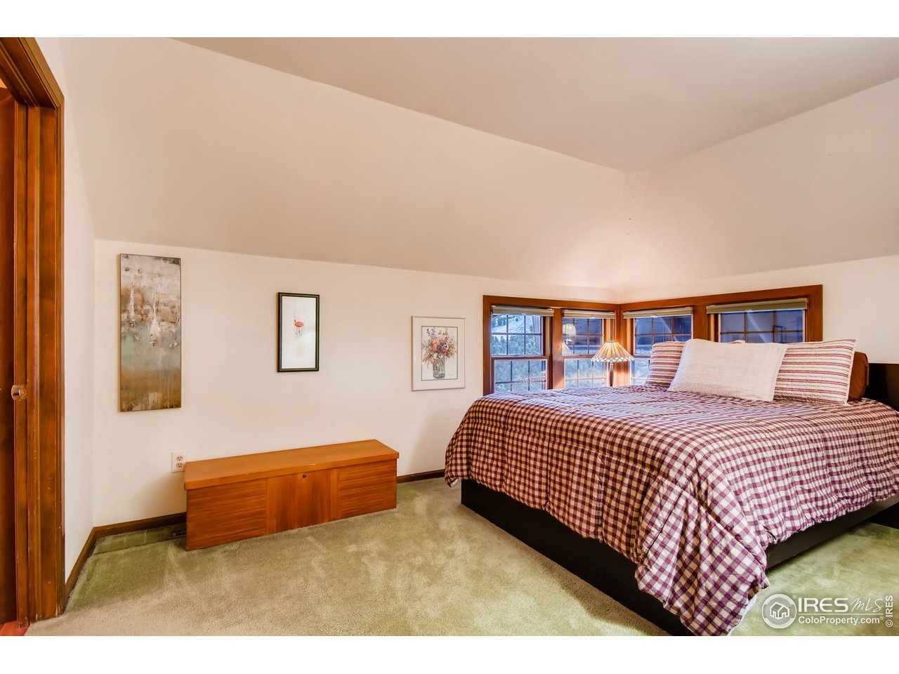 6325 Red Hill Road Boulder, CO 80302 - Photo 16 of 40 a bedroom with a bed and painting on the wall