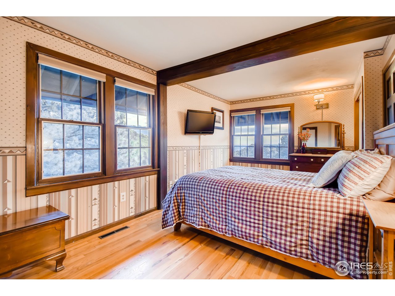 6325 Red Hill Road Boulder, CO 80302 - Photo 20 of 40 a bedroom with a bed and wooden floor