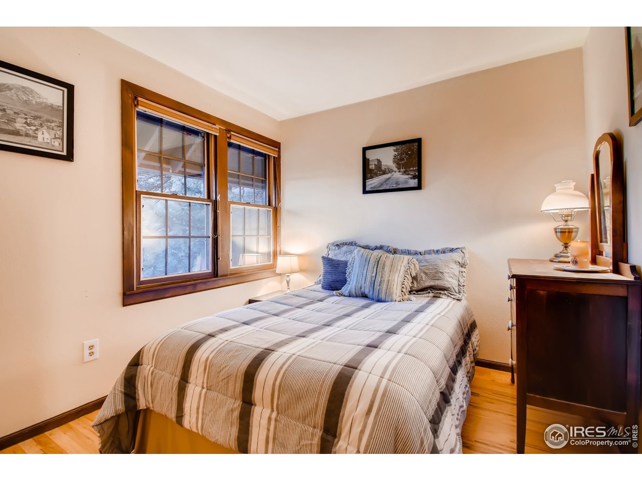 6325 Red Hill Road Boulder, CO 80302 - Photo 24 of 40 a bedroom with a bed and wooden floor