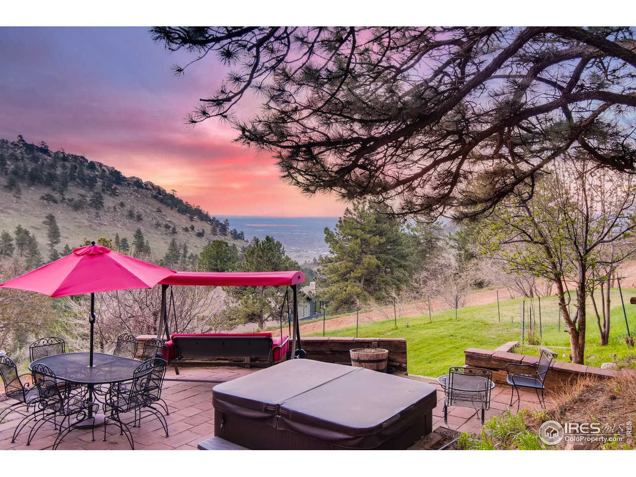 6325 Red Hill Road Boulder, CO 80302 - Photo 30 of 40 a view of a patio with couches table and chairs under an umbrella