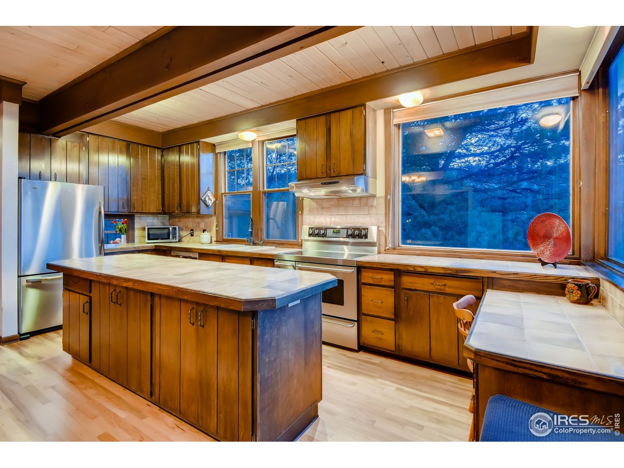 6325 Red Hill Road Boulder, CO 80302 - Photo 6 of 40 a kitchen with stainless steel appliances granite countertop a sink and wooden cabinets