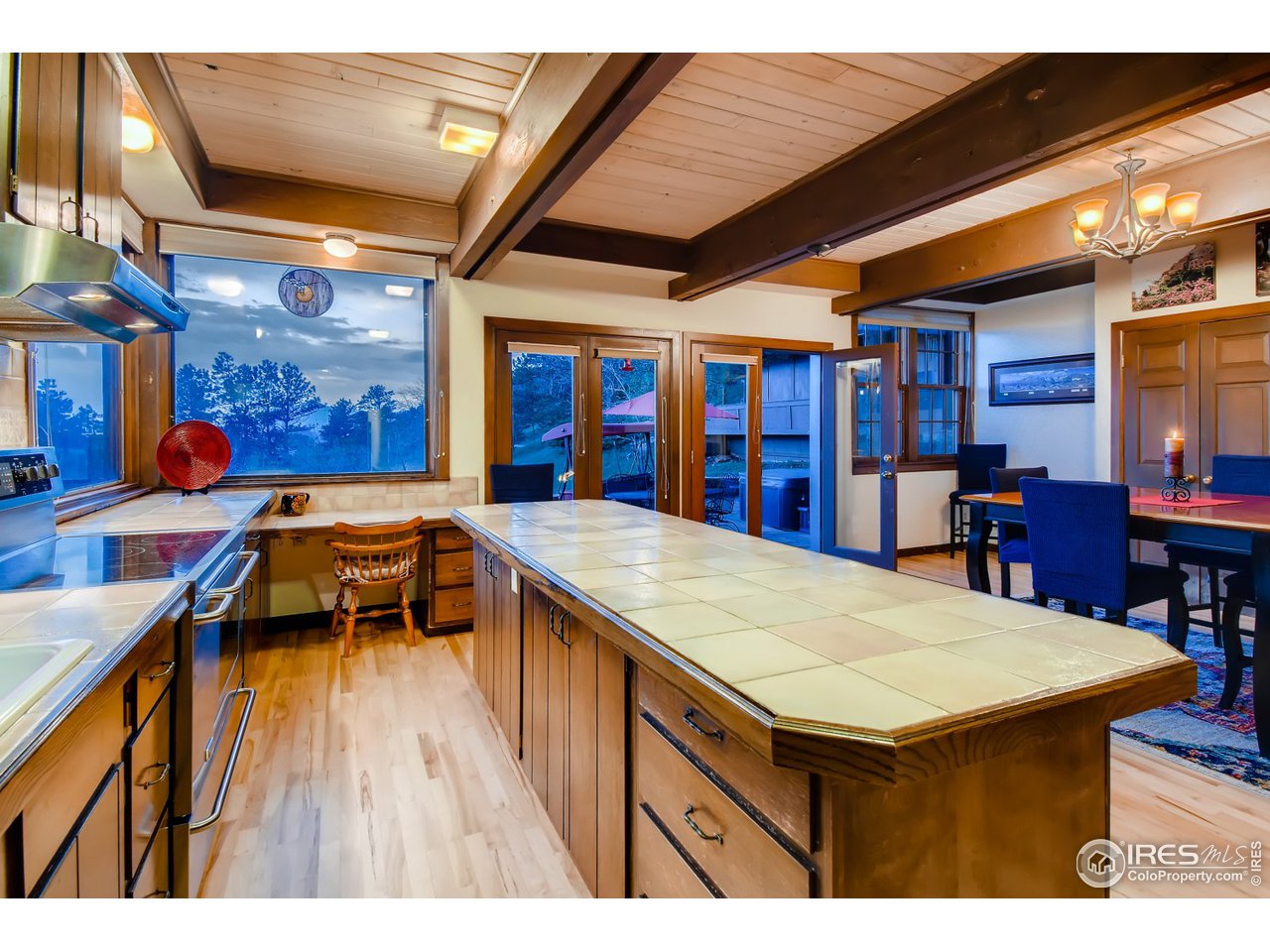 6325 Red Hill Road Boulder, CO 80302 - Photo 7 of 40 a kitchen with a table chairs and a wooden floor