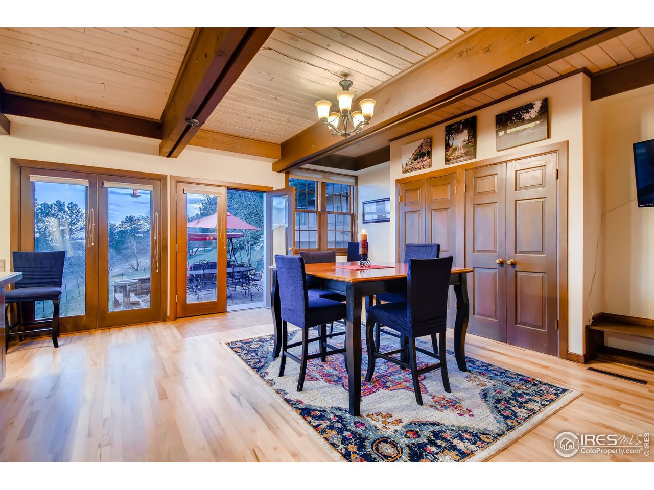 6325 Red Hill Road Boulder, CO 80302 - Photo 9 of 40 a dining room with furniture a rug a rug and a painting