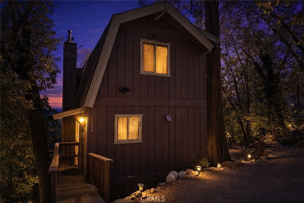 The front yard at 1226 Bridal Path, Rimforest CA 92378 at twilight. AI ENHANCED.