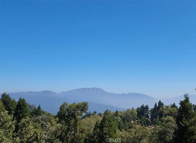 an aerial view of a house with mountain view