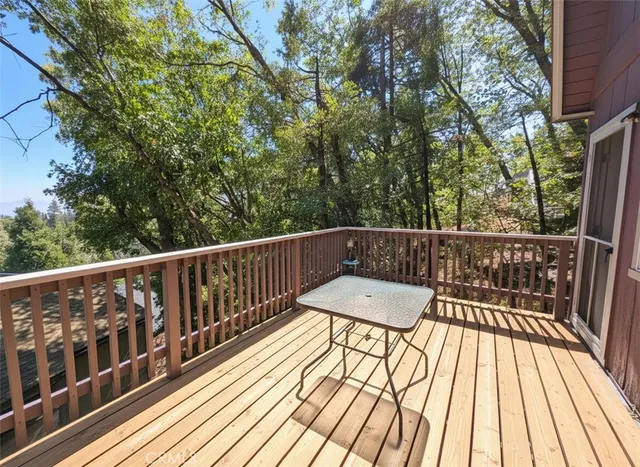 a view of balcony with wooden floor and fence