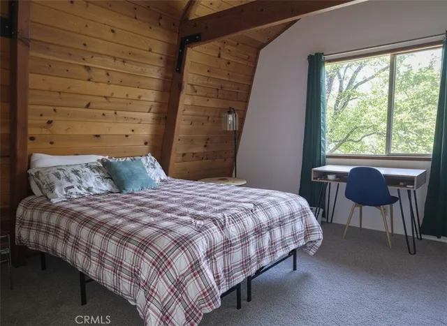 a bedroom with a bed chair and a window