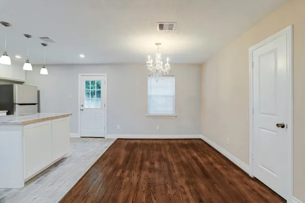 a view of a room with wooden floor and window