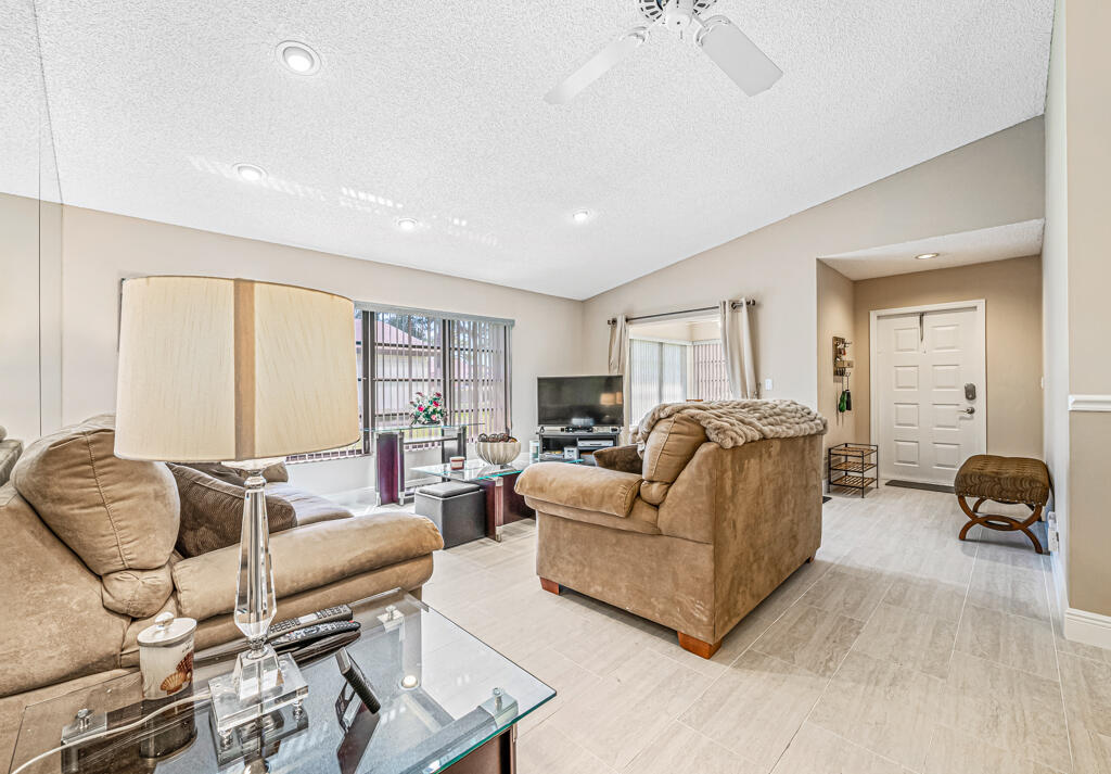 5121 Nesting Way, Unit D Delray Beach, FL 33484 - Photo 12 of 34 a living room with furniture and a lamp