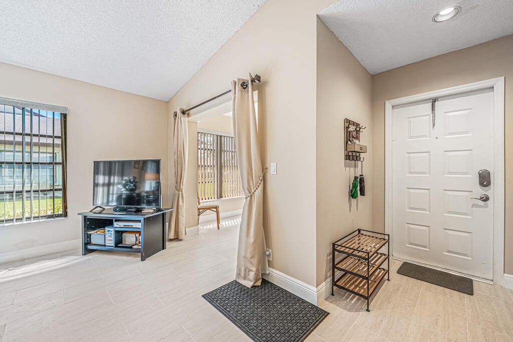 5121 Nesting Way, Unit D Delray Beach, FL 33484 - Photo 13 of 34 wooden floor and windows in a room