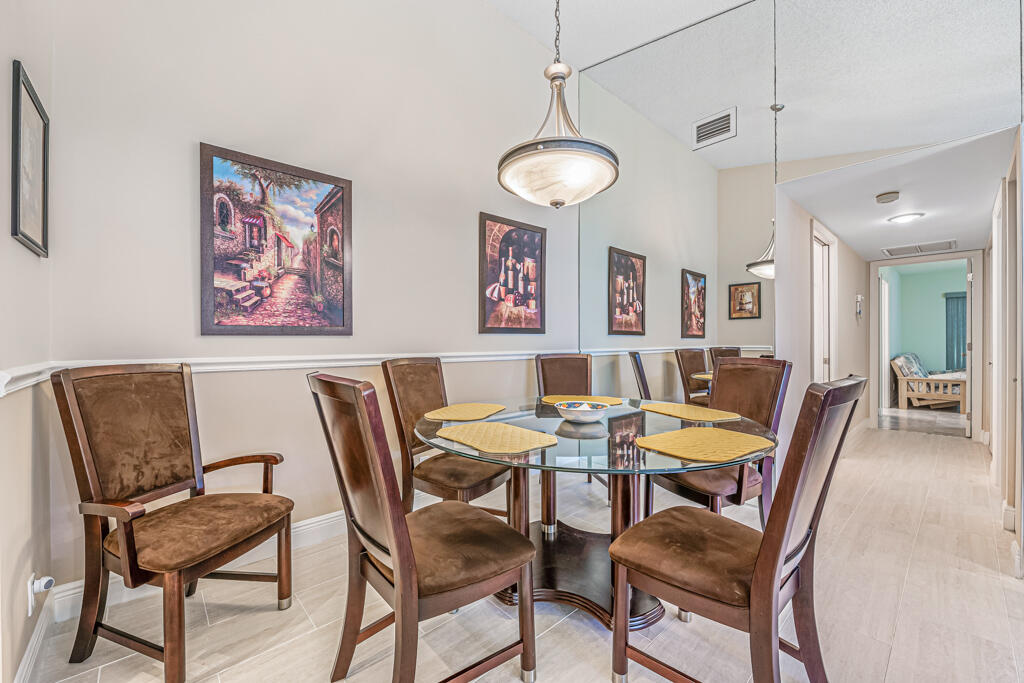 5121 Nesting Way, Unit D Delray Beach, FL 33484 - Photo 14 of 34 a view of a dining room with furniture and wooden floor