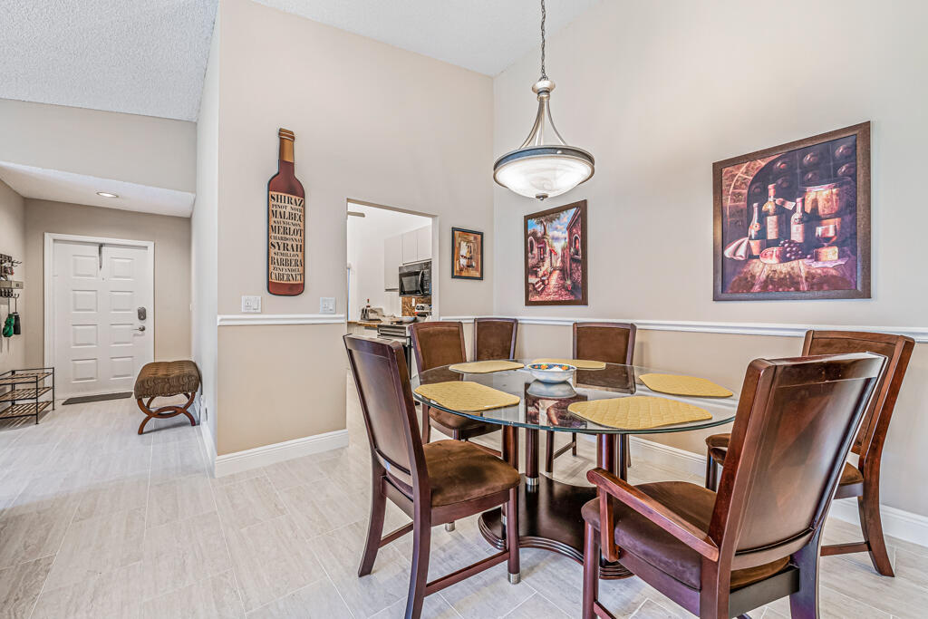 5121 Nesting Way, Unit D Delray Beach, FL 33484 - Photo 15 of 34 a view of a dining room with furniture