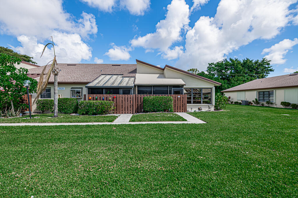 5121 Nesting Way, Unit D Delray Beach, FL 33484 - Photo 3 of 34 a front view of house with yard and green space