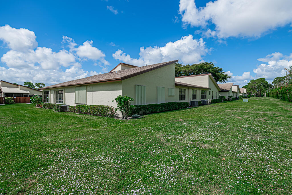5121 Nesting Way, Unit D Delray Beach, FL 33484 - Photo 32 of 34 a view of a house with a back yard