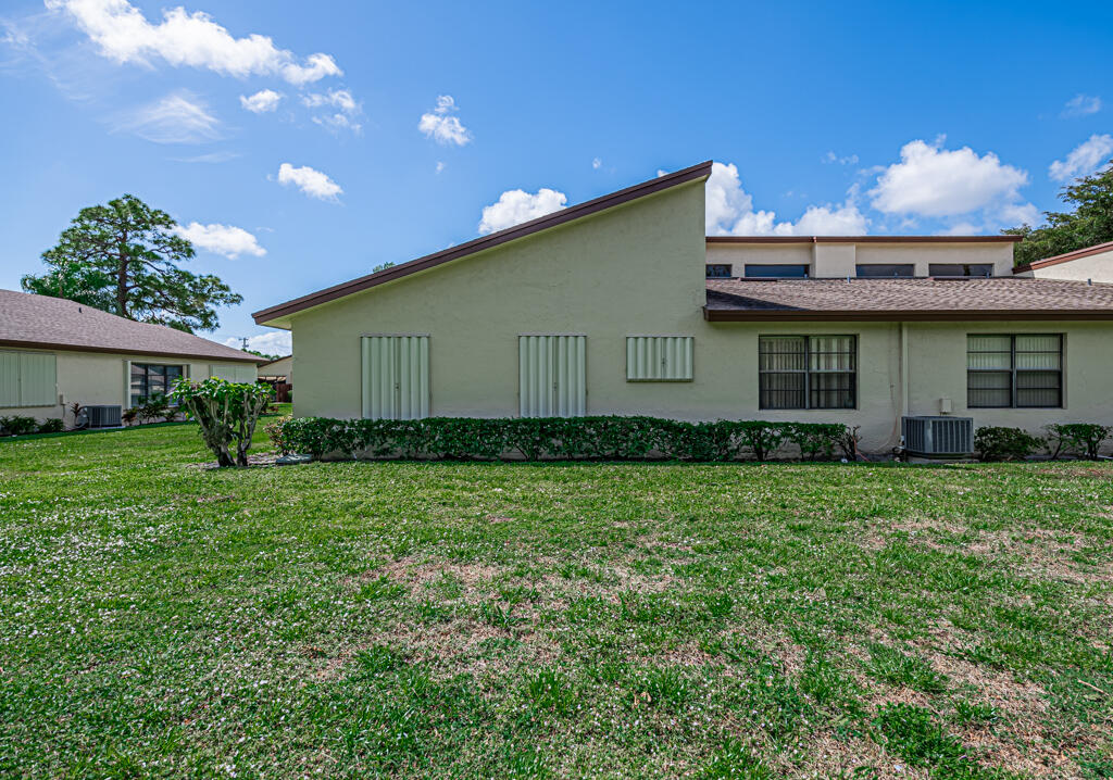 5121 Nesting Way, Unit D Delray Beach, FL 33484 - Photo 33 of 34 a front view of house with a garden