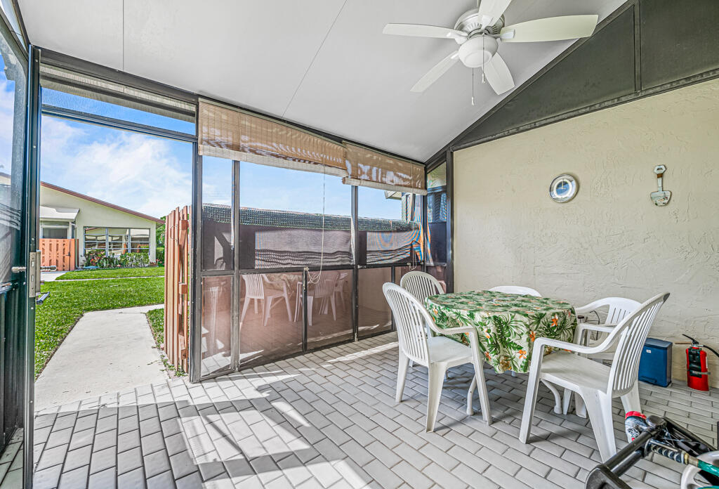 5121 Nesting Way, Unit D Delray Beach, FL 33484 - Photo 7 of 34 a view of a patio with table and chairs and potted plants