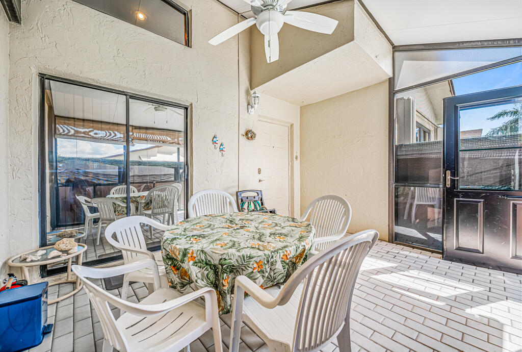 5121 Nesting Way, Unit D Delray Beach, FL 33484 - Photo 8 of 34 a view of a dining room with furniture a chandelier and wooden floor