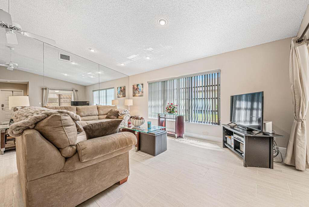 5121 Nesting Way, Unit D Delray Beach, FL 33484 - Photo 9 of 34 a living room with furniture window and wooden floor