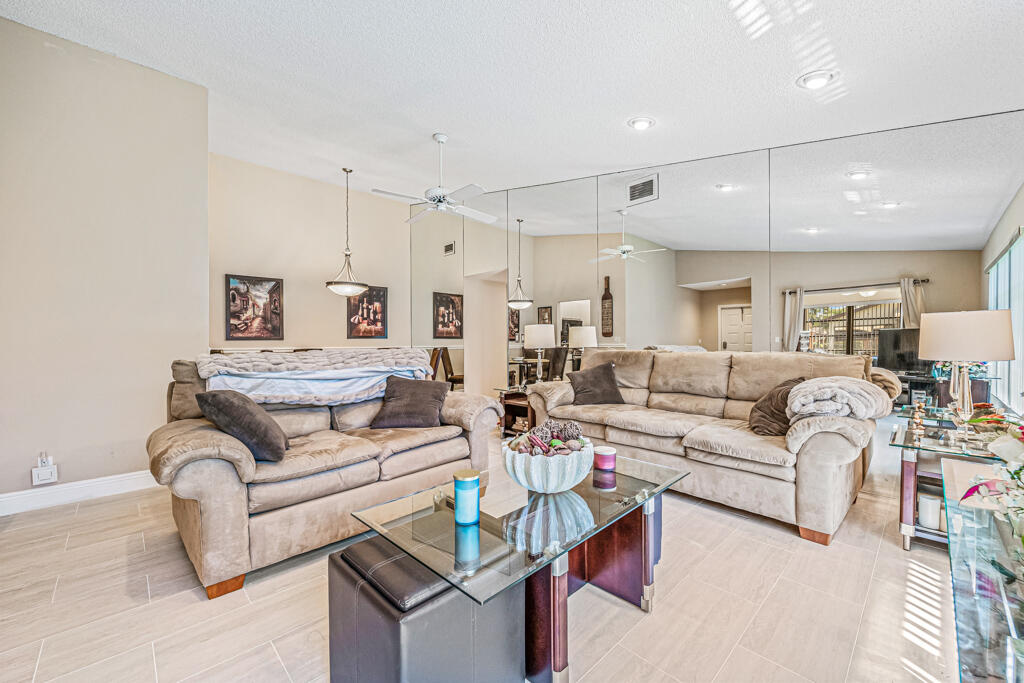 5121 Nesting Way, Unit D Delray Beach, FL 33484 - Photo 10 of 34 a living room with furniture white walls and white walls