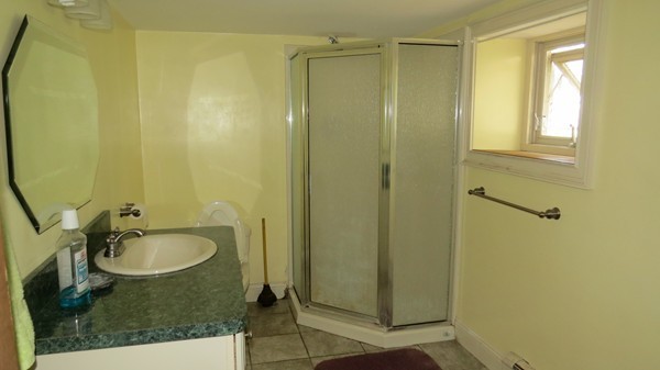 8 Manomet Road Woburn, MA 01801 - Photo 12 of 16 a bathroom with a granite countertop sink and a mirror