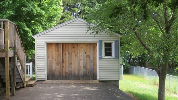 8 Manomet Road Woburn, MA 01801 - Photo 16 of 16 a view of a small house with large window and wooden fence