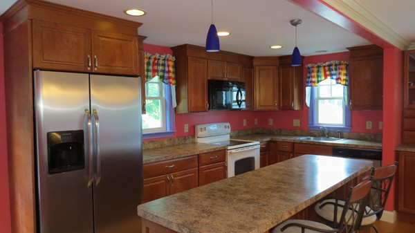 8 Manomet Road Woburn, MA 01801 - Photo 2 of 16 a kitchen with stainless steel appliances granite countertop a refrigerator a sink a stove and cabinets