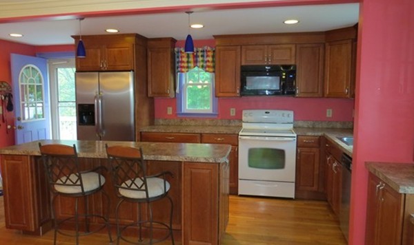 8 Manomet Road Woburn, MA 01801 - Photo 3 of 16 a kitchen with furniture a counter space and stainless steel appliances