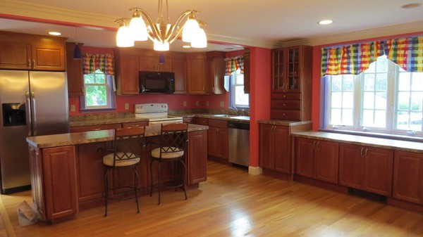 8 Manomet Road Woburn, MA 01801 - Photo 4 of 16 a kitchen with stainless steel appliances granite countertop a stove a sink dishwasher and a microwave