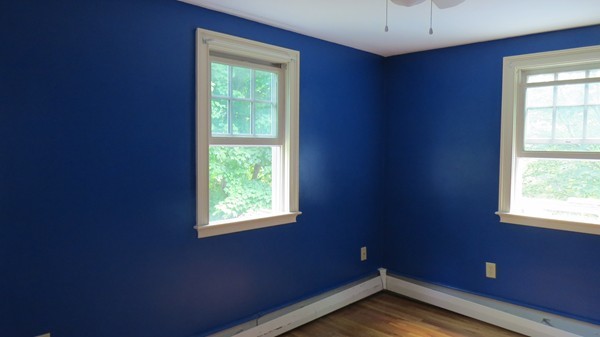 8 Manomet Road Woburn, MA 01801 - Photo 7 of 16 a view of an empty room with wooden floor and a window