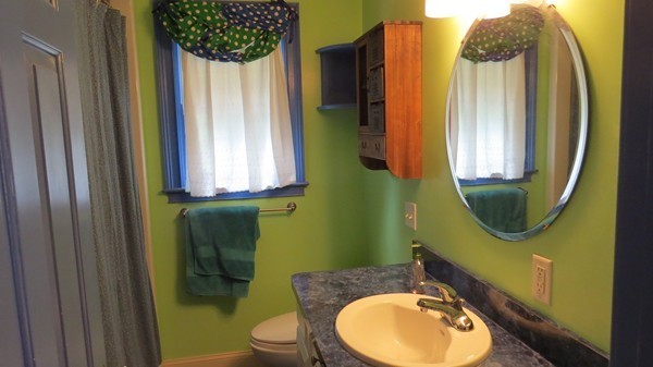 8 Manomet Road Woburn, MA 01801 - Photo 9 of 16 a bathroom with a toilet mirror and vanity
