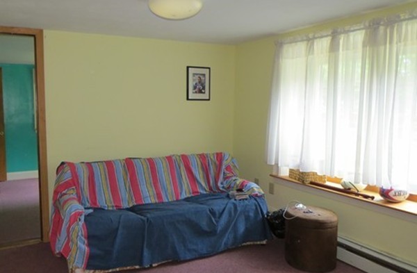 8 Manomet Road Woburn, MA 01801 - Photo 10 of 16 a living room with a couch and a window