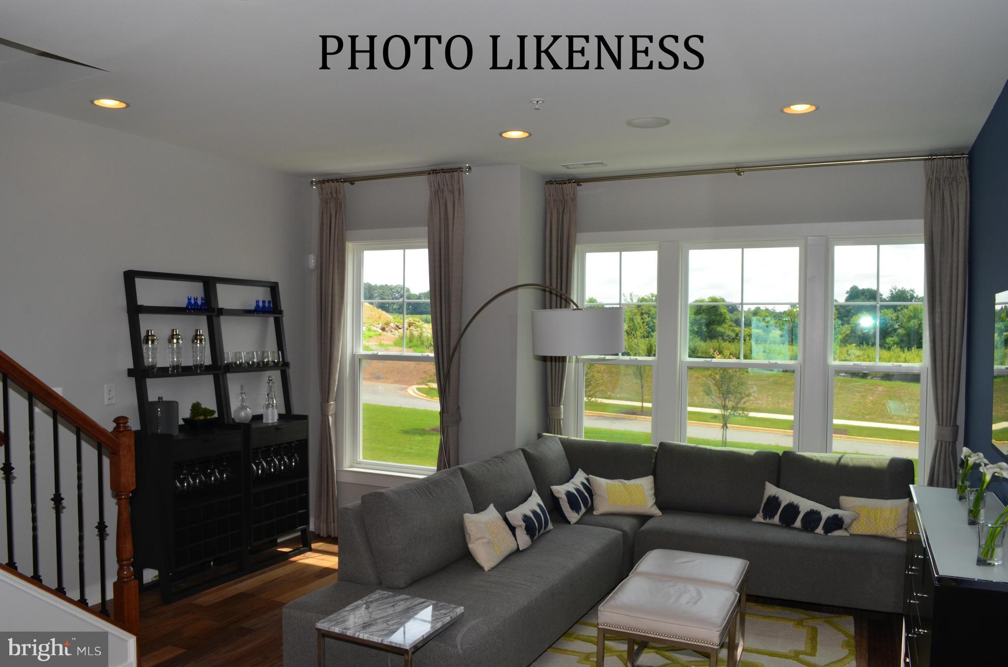 127 Decoverly Drive Gaithersburg, MD 20878 - Photo 14 of 30 a living room with furniture and a floor to ceiling window