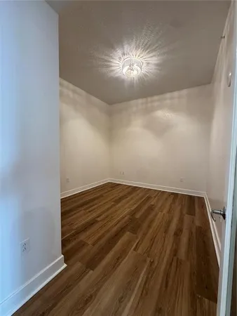 a view of a room with wooden floor and staircase