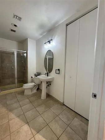 a view of a bathroom with a sink and a mirror