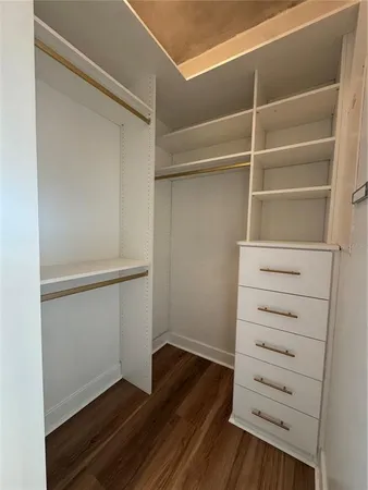 a view of walk in closet with empty racks