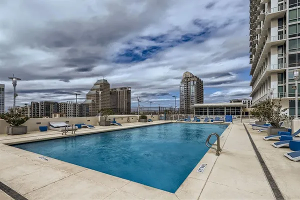 a view of a swimming pool with outdoor seating
