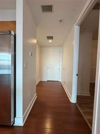 a view of hallway with wooden floor