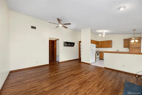 a view of a kitchen with wooden floor and a sink